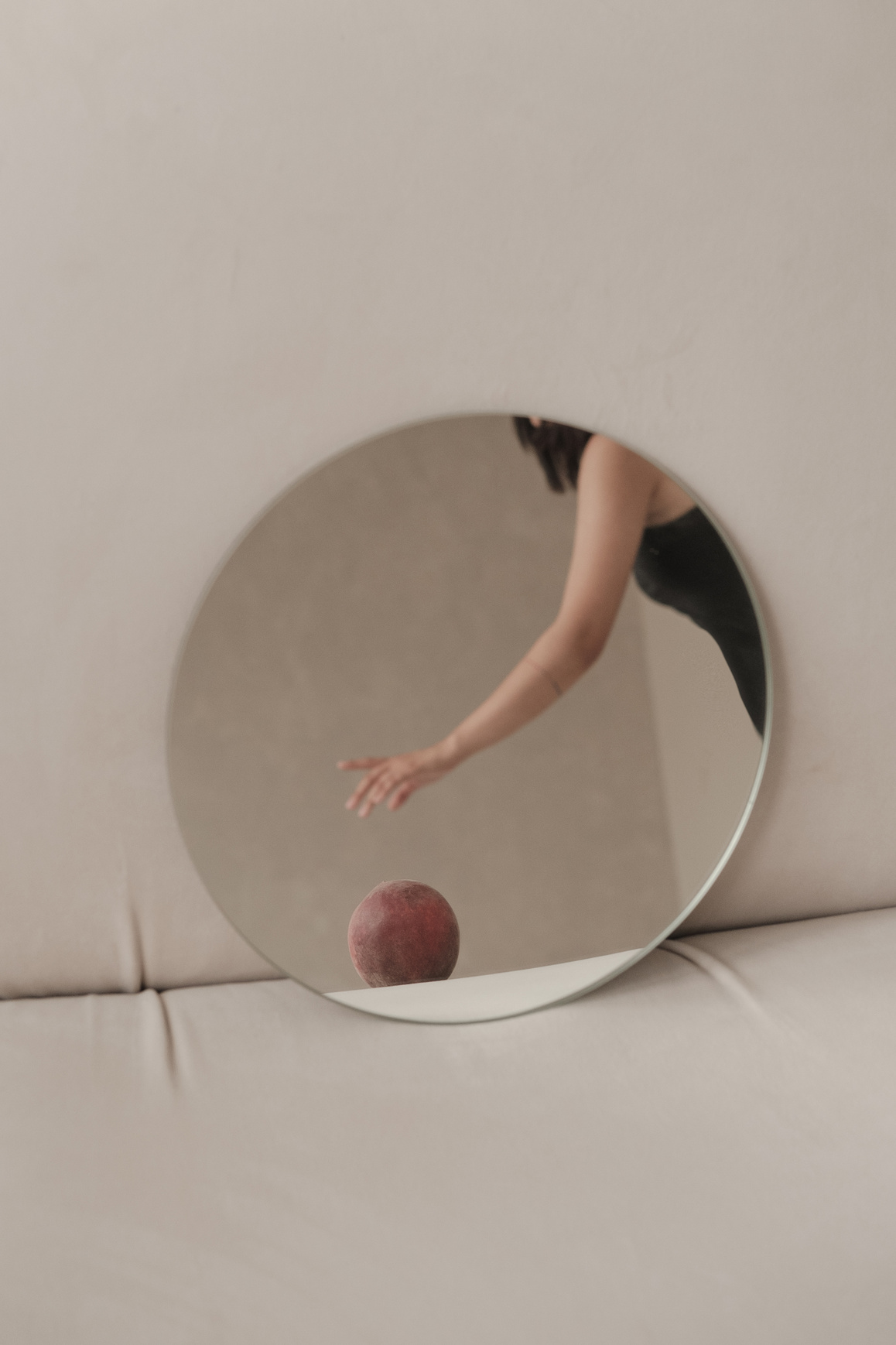 Woman as Seen on Round Mirror